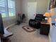 Comfortable room with a recliner, desk, exercise bike, and window with blinds at 112 Cr 532B, Bushnell, FL 33513