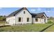 Elegant exterior showcasing a modern farmhouse design with a garage at 112 Cr 532B, Bushnell, FL 33513