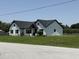 Beautiful exterior view of a modern farmhouse with white siding and a well-maintained lawn at 112 Cr 532B, Bushnell, FL 33513