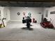 Spacious garage featuring a motorcycle, lawnmower, and extra storage space at 112 Cr 532B, Bushnell, FL 33513