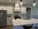 Modern kitchen with stainless steel appliances, white cabinets, and a center island with seating at 112 Cr 532B, Bushnell, FL 33513