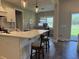 Kitchen island with seating and pendant lighting, open to a dining area and backyard views at 112 Cr 532B, Bushnell, FL 33513