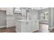 Bright, open kitchen with white cabinets, a large island, and stainless steel appliances at 112 Cr 532B, Bushnell, FL 33513