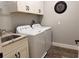 Functional laundry room with a sink, granite countertop, and modern washer and dryer at 112 Cr 532B, Bushnell, FL 33513