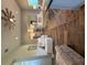 Open concept living room flowing into the kitchen with dark plank flooring and modern decor at 112 Cr 532B, Bushnell, FL 33513