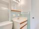 Bright bathroom featuring updated vanity, classic tiles and a mirrored medicine cabinet at 1511 Avenue F Ne, Winter Haven, FL 33881
