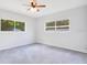 Spacious bedroom with gray carpeting and two large windows for plenty of natural light at 1511 Avenue F Ne, Winter Haven, FL 33881