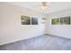 Cozy bedroom with gray carpeting and dual windows providing ample natural light at 1511 Avenue F Ne, Winter Haven, FL 33881