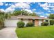 Charming single-story home with a well-maintained lawn, brick accents, and a beautiful green front door at 1511 Avenue F Ne, Winter Haven, FL 33881