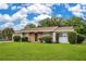 Charming single-story home with a well-maintained lawn, brick accents, and a beautiful green front door at 1511 Avenue F Ne, Winter Haven, FL 33881