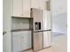 Modern kitchen features stainless steel appliances and light blue cabinetry, perfect for cooking and entertaining at 1511 Avenue F Ne, Winter Haven, FL 33881