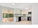 Modern kitchen with stainless steel appliances, light cabinetry, and sliding glass doors to lanai at 1511 Avenue F Ne, Winter Haven, FL 33881
