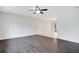 Spacious living room featuring wood-look tile flooring and a ceiling fan at 1511 Avenue F Ne, Winter Haven, FL 33881