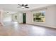 Bright living room features modern lighting, beautiful tile floors, a large window, and green front door at 1511 Avenue F Ne, Winter Haven, FL 33881