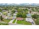 Aerial view of a residential neighborhood with mature trees and nearby community pool at 1511 Avenue F Ne, Winter Haven, FL 33881