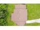Birds eye view showcasing the brown shingle roof of a home in a lush neighborhood at 1511 Avenue F Ne, Winter Haven, FL 33881