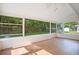Bright sunroom featuring hardwood floors and lots of windows with backyard views at 1511 Avenue F Ne, Winter Haven, FL 33881
