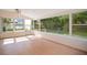 Sunroom with hardwood floors and an abundance of windows for natural light and outdoor views at 1511 Avenue F Ne, Winter Haven, FL 33881