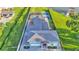 Home with a pool, solar panels, a pickleball court, and a patio on a well-manicured lot at 390 Windermere Dr, Lakeland, FL 33809