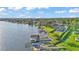 Picturesque aerial shot of a waterfront home with dock, showcasing lush greenery and expansive lake views at 390 Windermere Dr, Lakeland, FL 33809
