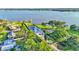 Lakeside home featuring an in-ground pool, sport court, and expansive grounds on the water at 390 Windermere Dr, Lakeland, FL 33809