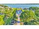 Gorgeous lakefront property featuring lush landscaping, a private driveway, and direct access to the serene lake at 390 Windermere Dr, Lakeland, FL 33809