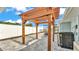 Backyard features a pergola, patio, and air conditioner unit at 390 Windermere Dr, Lakeland, FL 33809