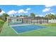 The exterior showcases a tennis court, screened-in pool, and light blue home with solar panels at 390 Windermere Dr, Lakeland, FL 33809