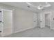 Spacious bedroom with neutral walls, white trim, and a modern ceiling fan at 390 Windermere Dr, Lakeland, FL 33809