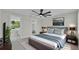 Cozy bedroom with a king-size bed, ceiling fan, and natural light, creating a comfortable and relaxing space at 390 Windermere Dr, Lakeland, FL 33809