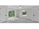 Bright bedroom with plush carpeting, ceiling fan, and sliding door access to the outdoors at 390 Windermere Dr, Lakeland, FL 33809
