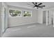 Bedroom featuring soft carpeting, an abundance of natural light and ensuite bathroom with walk-in closet at 390 Windermere Dr, Lakeland, FL 33809