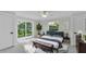 Bright primary bedroom features sliding glass door with a beautiful outdoor view and modern decor at 390 Windermere Dr, Lakeland, FL 33809