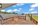 An exterior view from the deck with solar panels, overlooking the backyard and a serene lake at 390 Windermere Dr, Lakeland, FL 33809