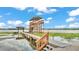 A private dock with a covered lookout tower extends into a lake, creating an idyllic waterfront experience at 390 Windermere Dr, Lakeland, FL 33809