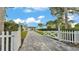 Charming home exterior with a paved driveway, manicured lawn and garden showcasing curb appeal at 390 Windermere Dr, Lakeland, FL 33809