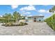 Inviting blue two-story home with a circular driveway, fountain, manicured hedges, and an attached two-car garage at 390 Windermere Dr, Lakeland, FL 33809