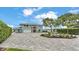 Attractive two-story home with a decorative fountain, modern door, and a expansive driveway at 390 Windermere Dr, Lakeland, FL 33809