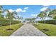 Elegant home featuring a long driveway, lush green lawns, and professionally landscaped surroundings, creating a welcoming entrance at 390 Windermere Dr, Lakeland, FL 33809