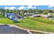 Waterfront property featuring a spacious lawn, screened pool, and charming neighborhood views at 390 Windermere Dr, Lakeland, FL 33809