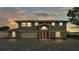Stunning home with a three-car garage and stone accents on a beautiful brick paved driveway at 390 Windermere Dr, Lakeland, FL 33809