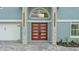 Inviting front entrance with a modern door, stone accents, and a two car garage at 390 Windermere Dr, Lakeland, FL 33809