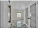 Hallway with marble floors leading to French doors and featuring modern decor and bright lighting at 390 Windermere Dr, Lakeland, FL 33809