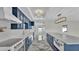 Spacious modern kitchen features custom blue cabinets, marble countertops and flooring, and stainless steel appliances at 390 Windermere Dr, Lakeland, FL 33809