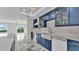 Modern blue kitchen with marble floors, stainless steel appliances and lake view at 390 Windermere Dr, Lakeland, FL 33809