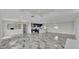 Open living space with modern lighting, fireplace, and a view of the gorgeous luxury kitchen at 390 Windermere Dr, Lakeland, FL 33809