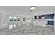 Bright living room boasts an open layout with luxury marble floors and a stylish blue kitchen at 390 Windermere Dr, Lakeland, FL 33809