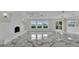 Open-concept living room featuring marble floors, a fireplace and lake view at 390 Windermere Dr, Lakeland, FL 33809