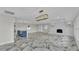 Bright open living space with luxury marble floors, modern fireplace and views into the kitchen at 390 Windermere Dr, Lakeland, FL 33809