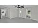 Spacious bedroom featuring soft carpeting, a ceiling fan and ensuite bathroom with a walk-in closet at 390 Windermere Dr, Lakeland, FL 33809
